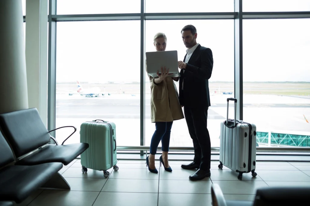 Viaggiatori con valigie in aeroporto vicino al Titian Inn Hotel Treviso per soggiorni business e trasferte